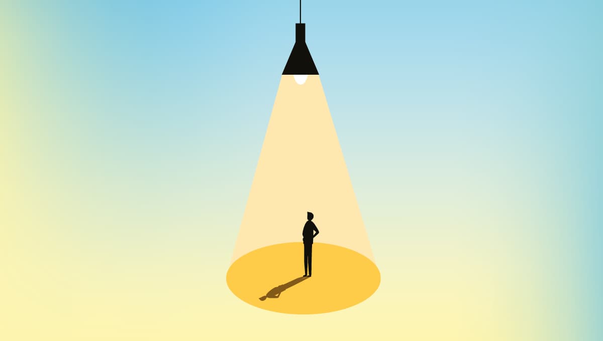 Man stands under light