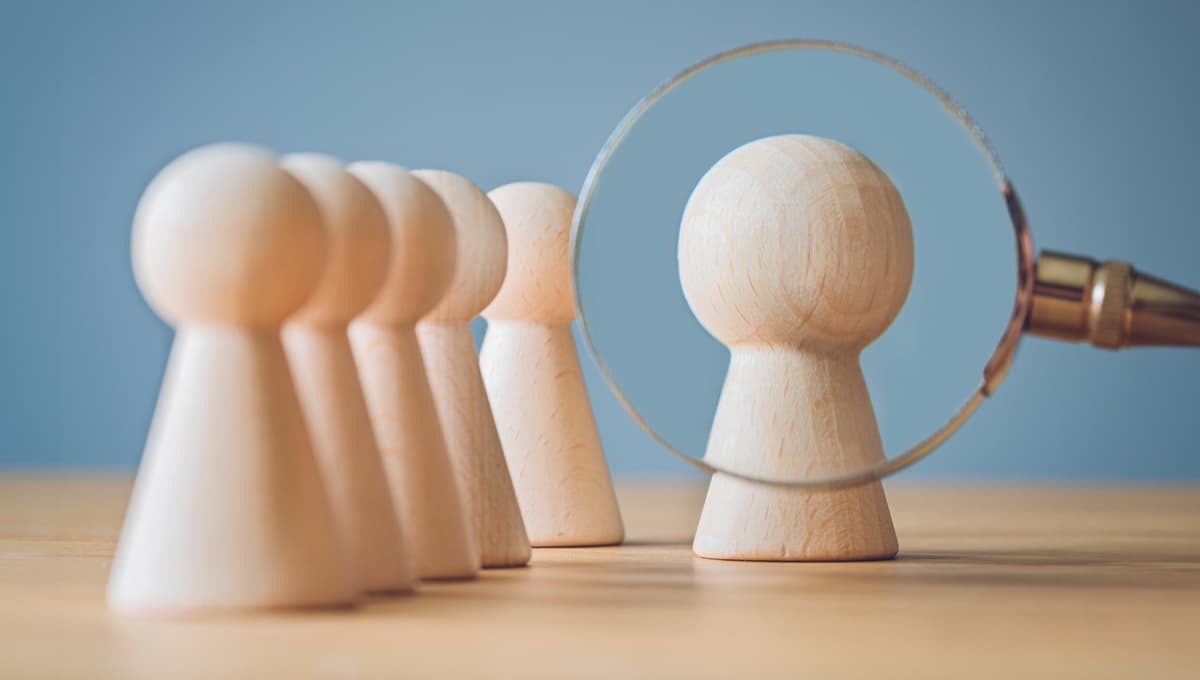 magnifying glass on pawns