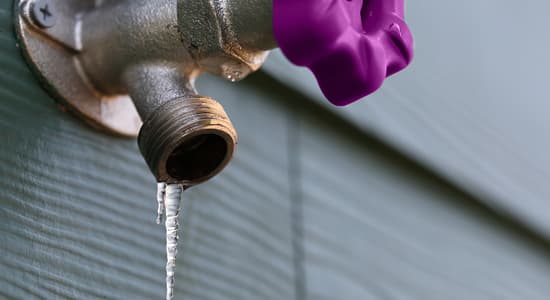An outdoor tap with an icicle frozen to the nozzle