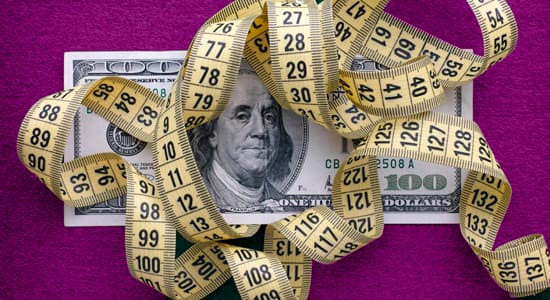 100 dollar bill with measuring tape
