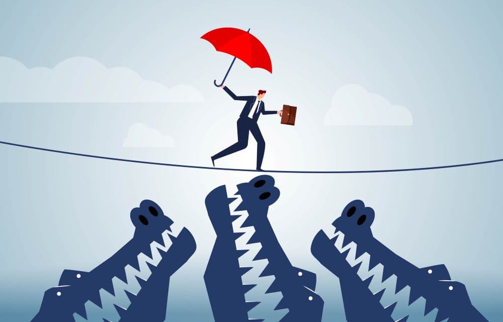 Illustration of a person balancing on a tight rope and trying to cross a chasm.