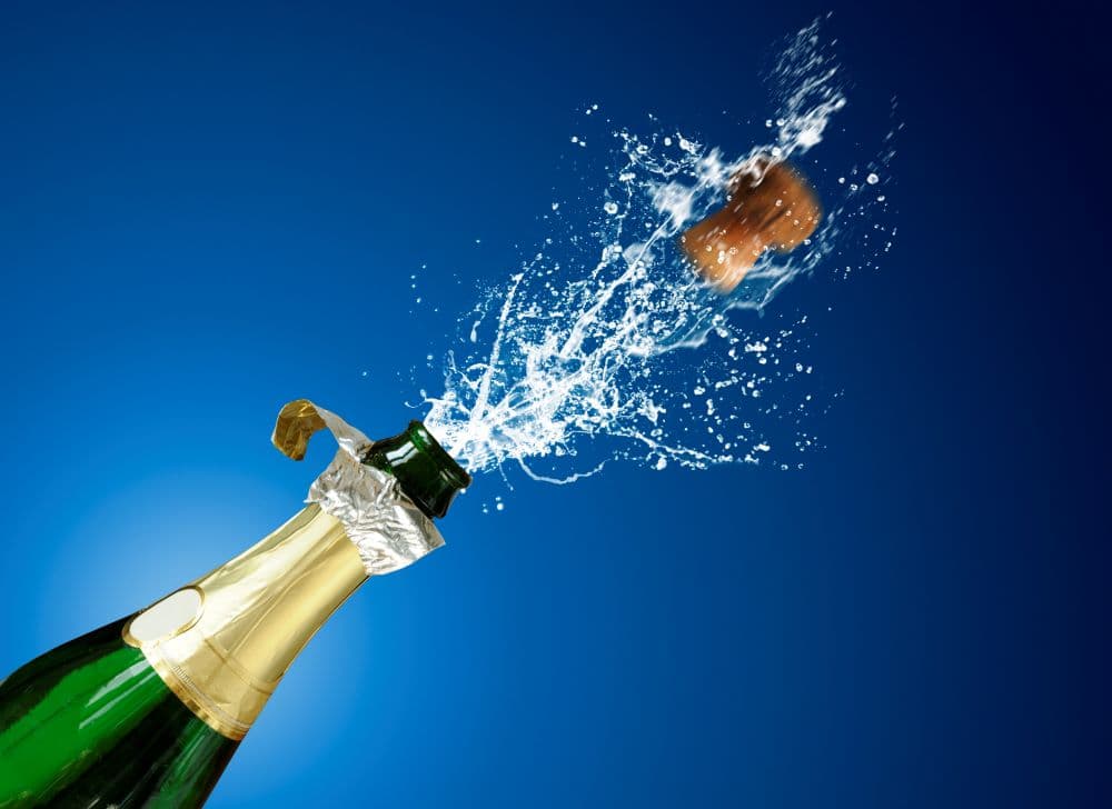Photo of champagne popping.