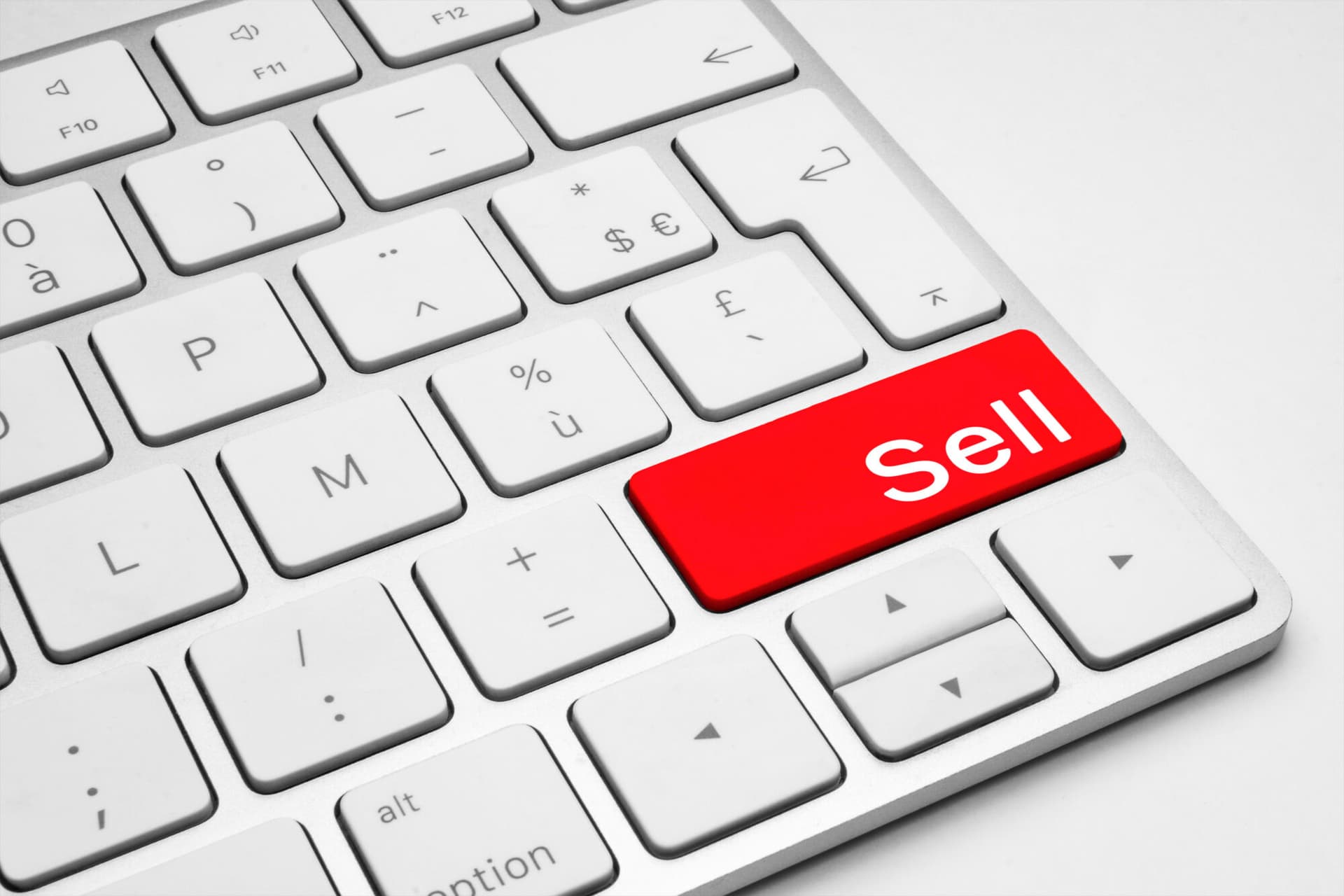 Red Sell button on a white keyboard isolated on a white background