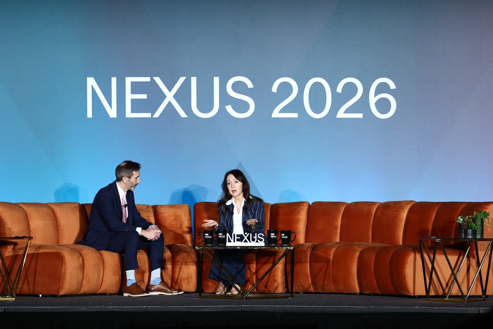 Photo of CalPERS CEO Marcie Frost speaking with Chris Witkowsky of PEI Group at NEXUS 2026.